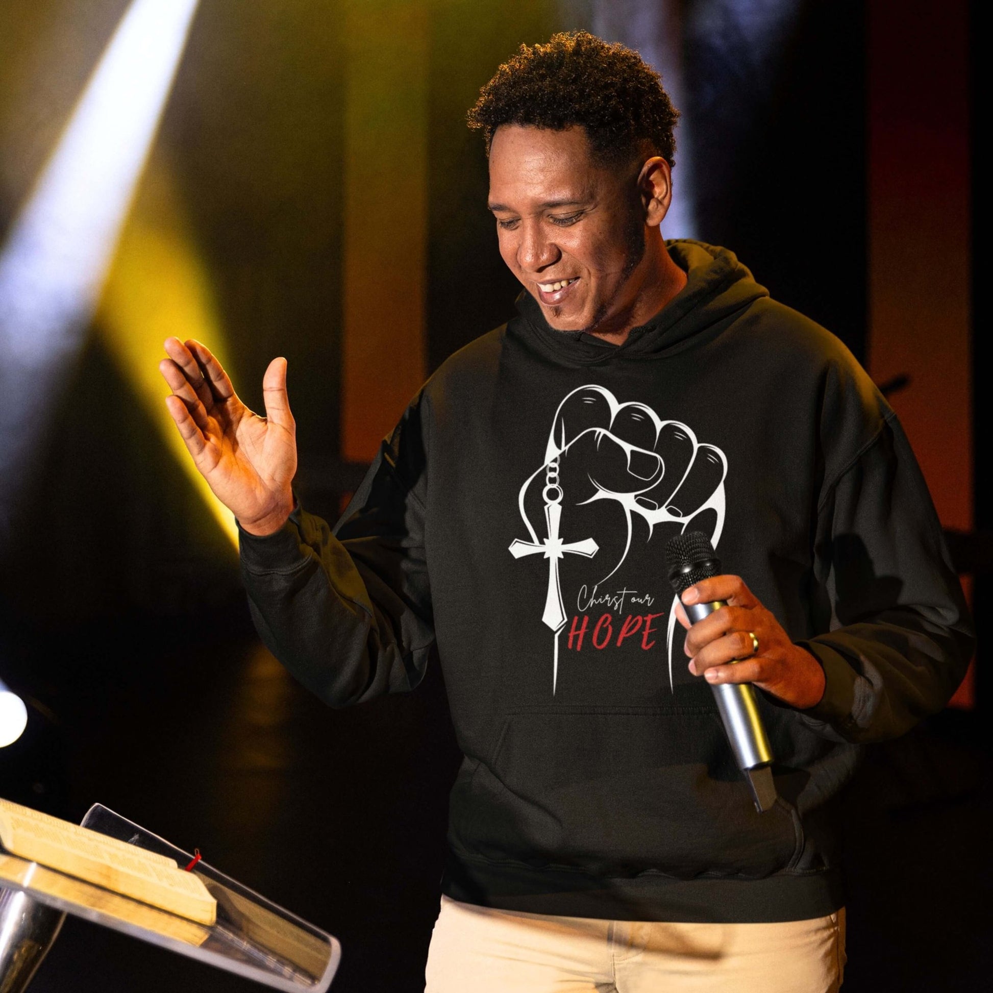 Man Wearing a Giant Slayer 'Christ Our Hope Hoodie' preaching on a church pulpit